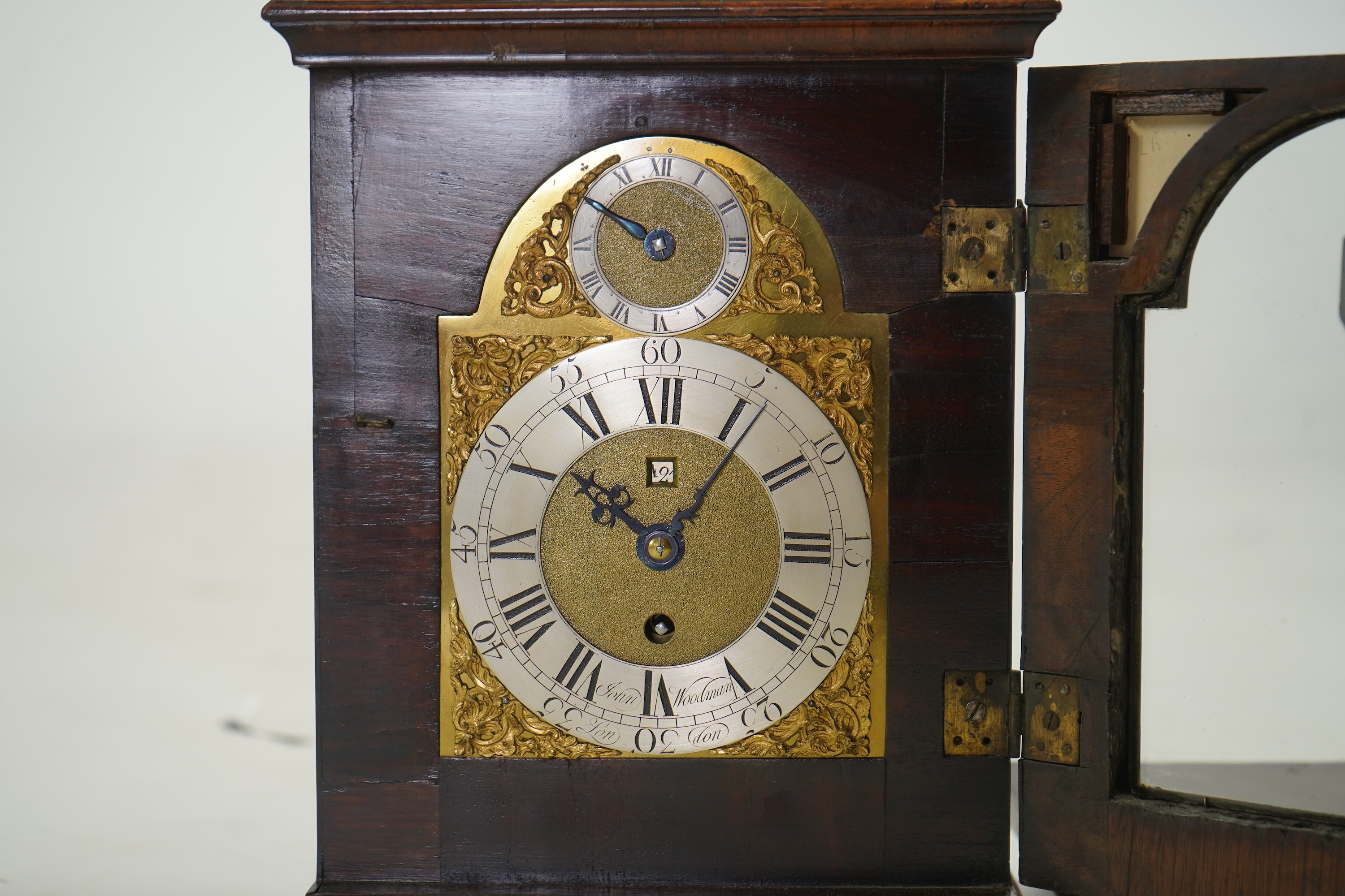 A George II walnut and brass mounted bracket clock, signed John Woodman